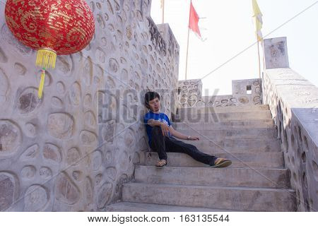 Asia man With Great Wall Of China model at Santichon village Chinese style village