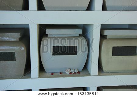 Urns with ashes in a columbarium wall