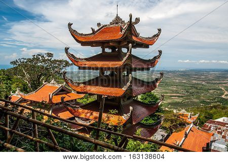 Buddhist temple on green mountain Vietnam TaCu