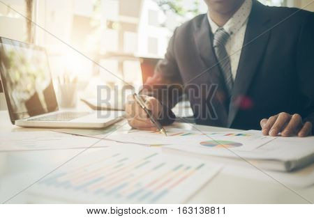 businessman working plan the business and analysis many chart graph. Film effected photo.
