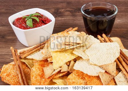 Heap Of Unhealthy Food, Sauce With Basil And Cola On Wooden Board