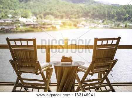 Relaxing wooden desk on wood terrace against beautiful view