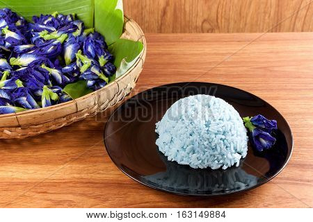 Blue Rice made cooking from Butterfly Pea flower (Clitoria ternatea L) in the black dish. Rice has a colorful and fragrant flower and good for health.