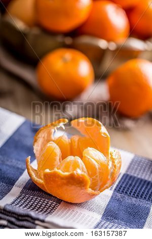Tangerines peeled tangerine and tangerine slices on a blue cloth. Mandarine juice.