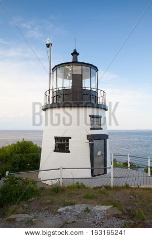 Small Castle Hill lighthouse in Newport Rhode Island overlooking the Atlantic Ocean built in 1830