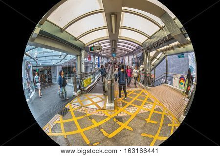 Hong Kong, China - December 4, 2016: fisheye view of Mid-levels escalator, a system of escalators and walkways connecting Central to Western District. The beginning of system on Queen's Road Central