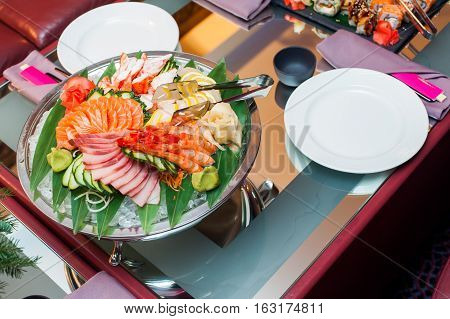 Asian food group of sushi and sashimi set with smoke on served table in restaurant.Selective focus