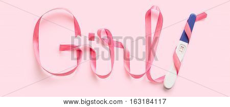 Word girl written gift ribbon pink. A positive pregnancy test. Pink background
