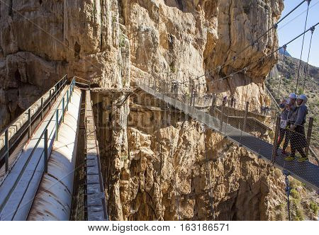 Malaga Spain - December 6 2016: people walking along the Caminito del Rey path Malaga Spain. They are taking pictures to theirselves over the suspension bridge of the gorge