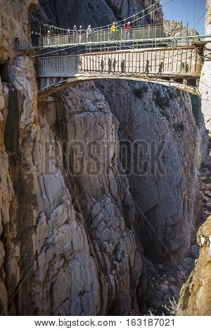 Malaga Spain - December 6 2016: people walking along the Caminito del Rey path Malaga Spain. They are taking pictures to theirselves over the suspension bridge of the gorge