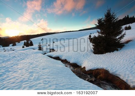 evening sunlight over mountain sriver in winter