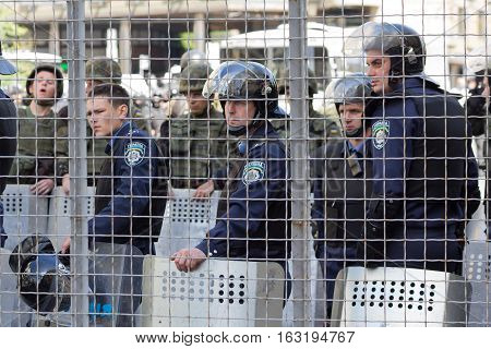 Kiev Ukraine - June 12 2016: Cordon of police clad in armor protecting the participants of the gay parade from the radicals