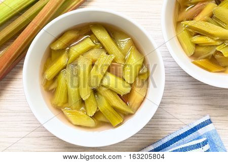 Fresh homemade rhubarb compote in two bowls photographed overhead with natural light (Selective Focus Focus on the top of the compote)