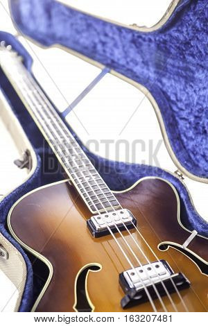 Vintage archtop semi-acoustic bass guitar in tweed case