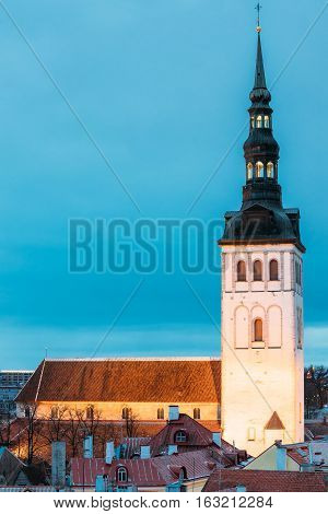 Traditional Old Ancient Architecture In Historic District Of Tallinn, Estonia. St. Nicholas Church - Niguliste Kirik Is A Medieval Church At Winter Evening Night. Famous Landmark.