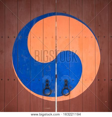 A symbol of Korea's iconic Taegeuk mark drawn on the old door in Suwon Korea