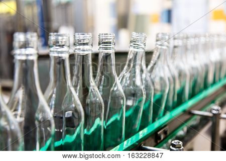 The Bottles On The Conveyor Belt At The Plant For Bottling Of Al