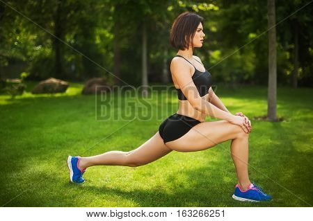 woman doing exercise on the grass in the Park