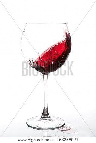 Red Wine Swirling In A Goblet Wine Glass, Isolated On A White Background