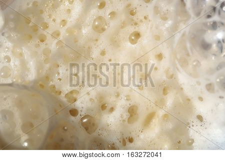 White froth of soda drink with bubbles background as abstract background