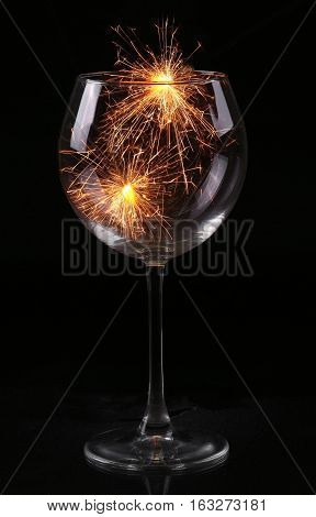 Wine Glass With A Sparkler. In Anticipation Of New Year And Christmas