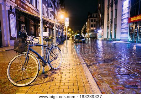 Riga, Latvia - July 4, 2016: Single Bicycle Bike Parking On Kungu Street In Old Part European Town In Summer Evening Night.