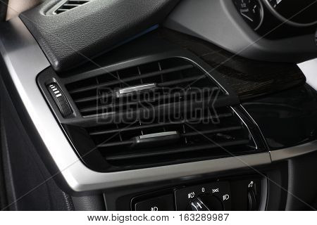 Interior of leather passenger compartment of the car in dark tones. Climate control