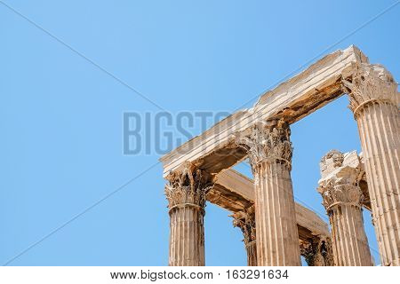 Looking up view of famous Greek temple pillars against clear blue sky in Temple of Zeus Greece