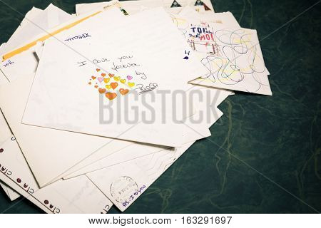 Big stack of mails pile of papers or heap of letters above a letter saying 