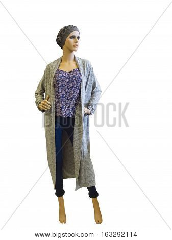 Full-length female mannequin wearing long cardigan top and blue jeans. Isolated on white background. No brand names or copyright objects.