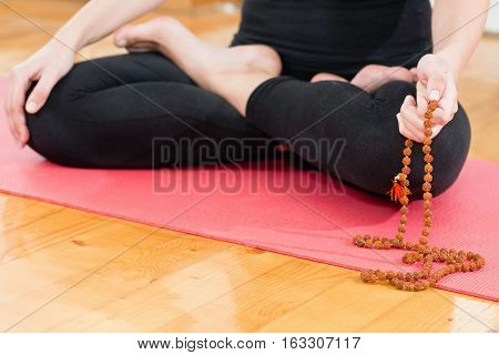 Meditating with Rudraksha beads, color image, horizontal