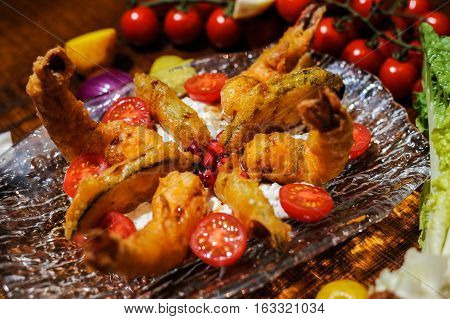 Crispy tempure battered fried prawns served with aubergine, cougterre, tzatziki and pomegranate sauce