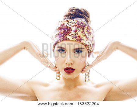 young pretty modern girl with bright shawl on head emotional posing isolated on white background, asian people ethnicity