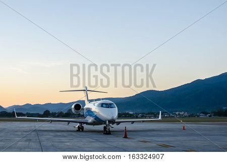 Small Airplane or Aeroplane Parked at Airport.Small Airplane Famous to use Private Airplane.Sunset Light and Mountain View.