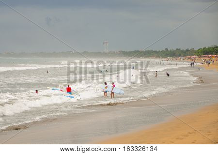 Bali,Indonesia-May 28,2010:People enjoying a fun day at Kuta beach at Bali,Indonesia,also known as Sunset Beach,another name for Sanur Beach.