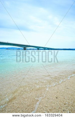 Kouri island bridge with beautiful sea level with blue sky in Okinawa Japan