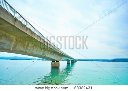 Kouri island bridge with beautiful sea level with blue sky in Okinawa Japan
