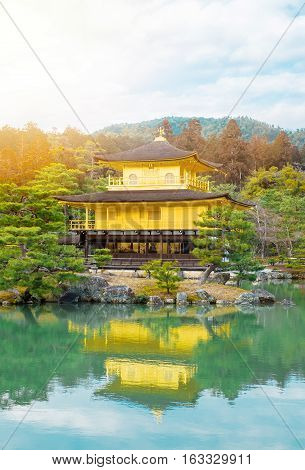 The world cultural heritage Kinkaku Ji under dramatic morning sunshine the traditional golden zen buddhist temple in Kyoto Japan
