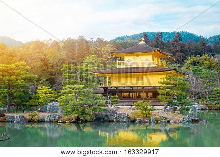 The world cultural heritage Kinkaku Ji under dramatic morning sunshine the traditional golden zen buddhist temple in Kyoto Japan