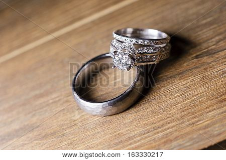A pair of wedding rings on wood