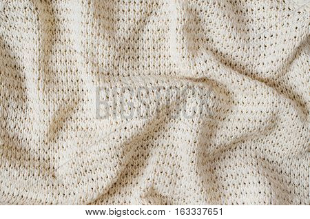Vintage Beige Knitted Fabric Texture. Crochet Warm Woolen Yarn Background. Close-up. Selective focus.