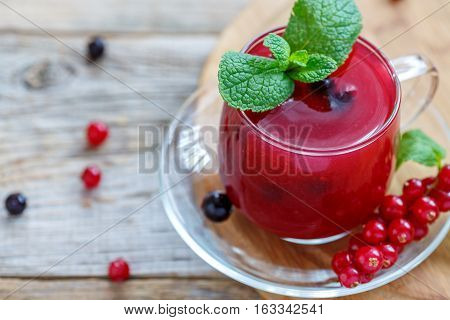 Cup With Berry Kissel, Mint And Red Currant Close Up.