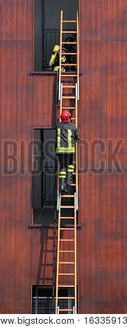 Fireman Climbs Up The Ladder During A Training Exercise