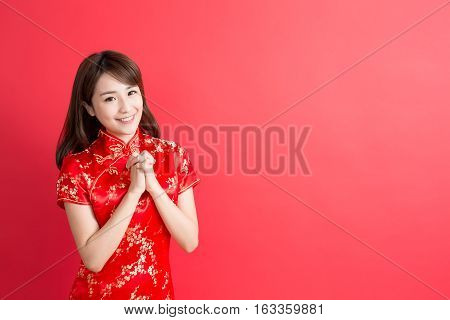 beauty woman wear cheongsam and smile to you in chinese new year