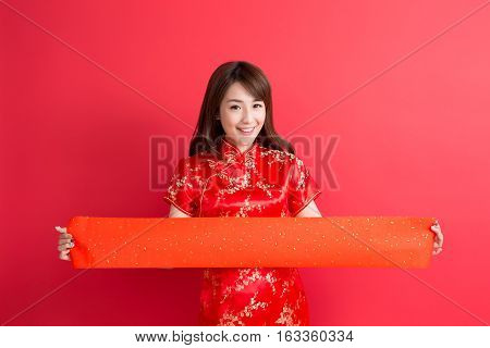 beauty woman wear cheongsam and show couplets with chinese new year