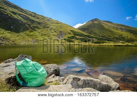 view on mountains lake with backbag in ukrainian Carpatu