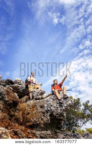 Two men in the beautiful mountains with backpacks and tents.