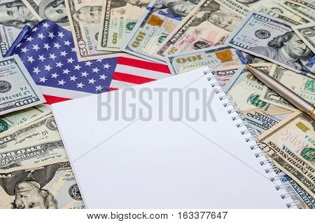 clean sheet of notebook with dollars and US flag