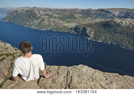 Norwegian fjord landscape. Hiker. Preikestolen landmark. Norway adventure tourism