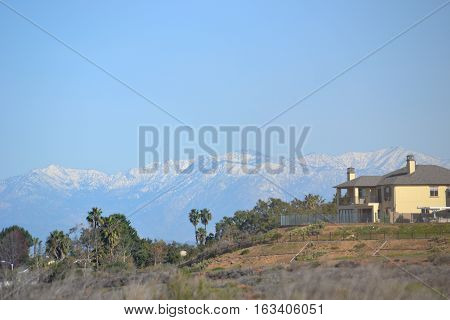 The snow capped San Gabriel Mountains seen from Bolsa Chica Ecological reserve in southern California, approximately 65 mile distance.